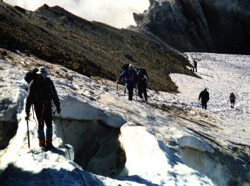 DJ crossing a snow bridge near the crater. Brad, Bruce, Kathy, and Drew follow.